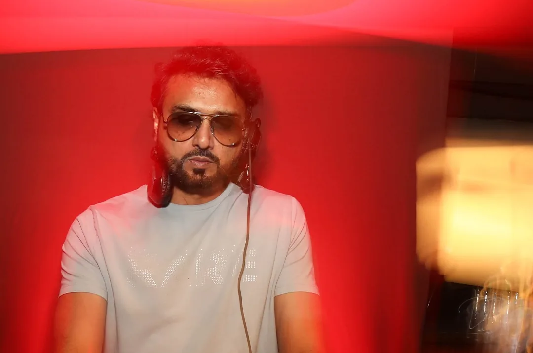 Piyush Mehta behind the decks under red light